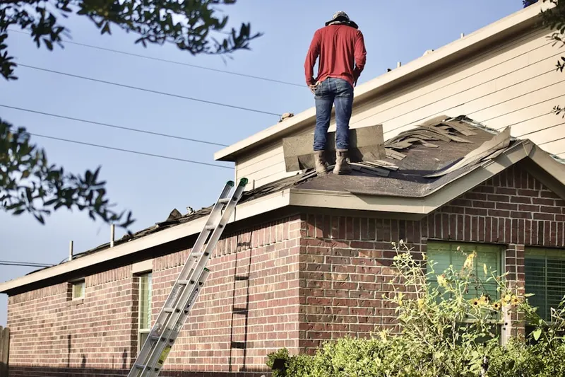 Professional roofer working on a residential roof in Salem Center
